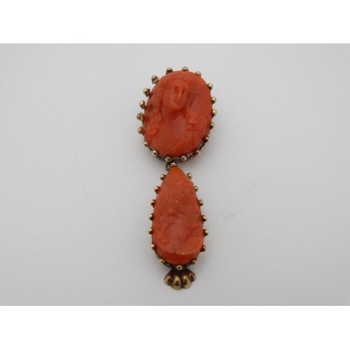 961 - A yellow metal brooch set with carved coral cameo like decoration with drop section under set with s... 