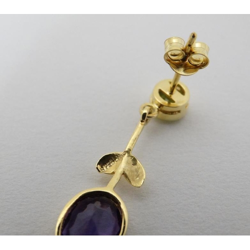 963 - A pair of silver gilt drop earrings set with amethysts and peridot 1 1/4'' long