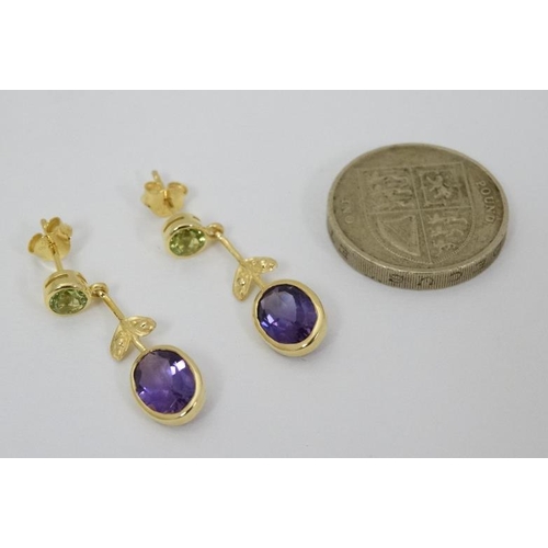 963 - A pair of silver gilt drop earrings set with amethysts and peridot 1 1/4'' long