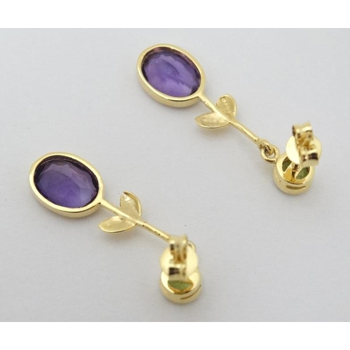 963 - A pair of silver gilt drop earrings set with amethysts and peridot 1 1/4'' long