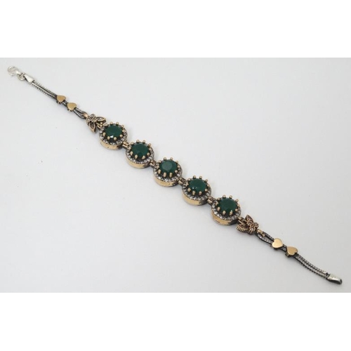 964 - A silver bracelet set with green and white stones with gilt decoration