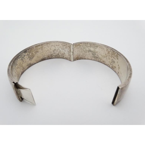 965 - A silver bracelet of bangle form marked 925