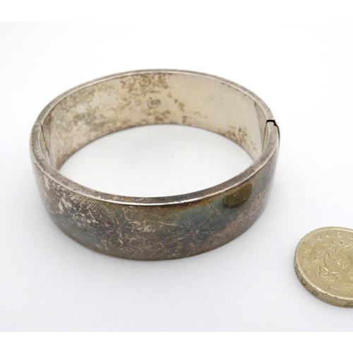 965 - A silver bracelet of bangle form marked 925