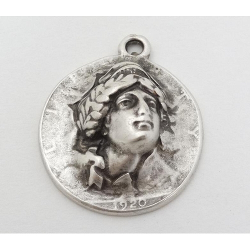 974 - A white metal pendant formed from a 1920 American half dollar  1 1/4'' long