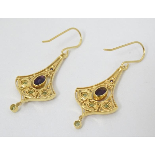 979 - A pair of silver gilt drop earrings set with amethyst, peridot and white stones. Approx 1 1/2'' long