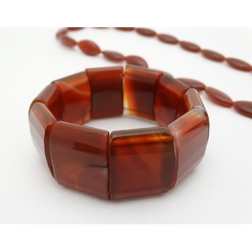 982 - A necklace of Cornelian hardstone beads together with Cornelian / Carnelian hardstone bracelet 92)