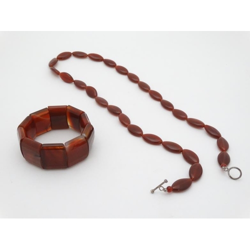 982 - A necklace of Cornelian hardstone beads together with Cornelian / Carnelian hardstone bracelet 92)