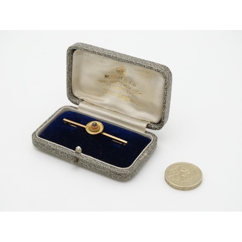 992 - A 9ct gold brooch set with central coral cabochon surmounted by a diamond. 1 3/4'' wide