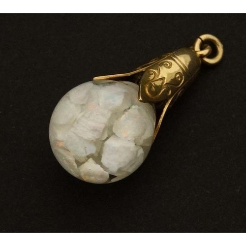 994 - A gilt metal pendant with glass sphere containing opal chips 1 1/4'' high