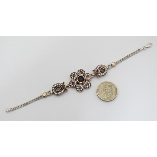 996 - A silver bracelet set with red and white stones and with gilt decoration