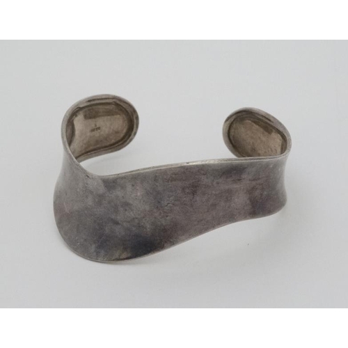 999 - A silver bracelet of bangle form