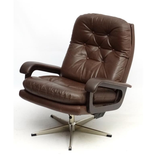 101 - Vintage Retro : A Danish brown leather open arm tilt and swivel button back chair , on a chromed 5 s... 