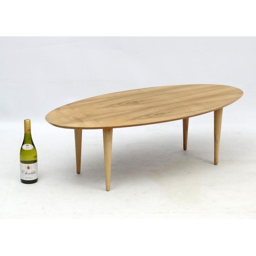 107 - Vintage Retro : an Afrormosia oval shaped coffee table with turned tapering beech legs , measuring 1... 