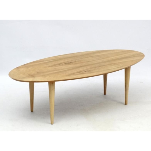 107 - Vintage Retro : an Afrormosia oval shaped coffee table with turned tapering beech legs , measuring 1... 