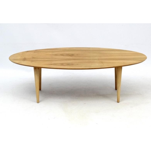 107 - Vintage Retro : an Afrormosia oval shaped coffee table with turned tapering beech legs , measuring 1... 