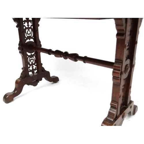 188 - A 19thC Elizabethan Revival oak writing table, with frieze drawer and decorative trestle ends. 42 3/... 