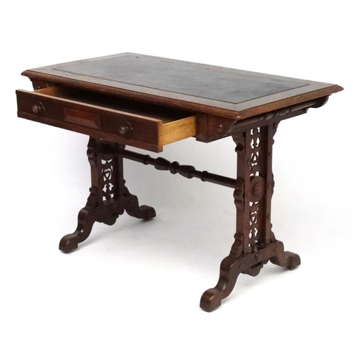 188 - A 19thC Elizabethan Revival oak writing table, with frieze drawer and decorative trestle ends. 42 3/... 