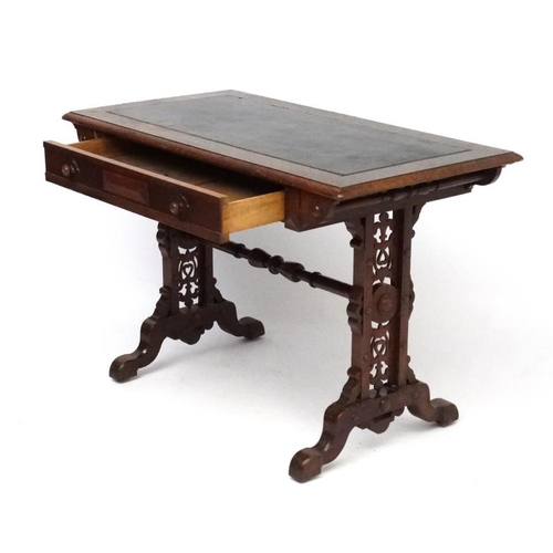 188 - A 19thC Elizabethan Revival oak writing table, with frieze drawer and decorative trestle ends. 42 3/... 