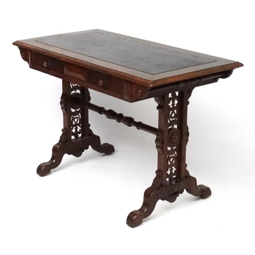 188 - A 19thC Elizabethan Revival oak writing table, with frieze drawer and decorative trestle ends. 42 3/... 