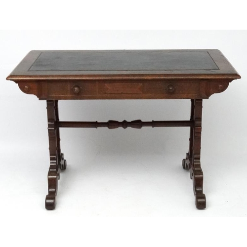 188 - A 19thC Elizabethan Revival oak writing table, with frieze drawer and decorative trestle ends. 42 3/... 