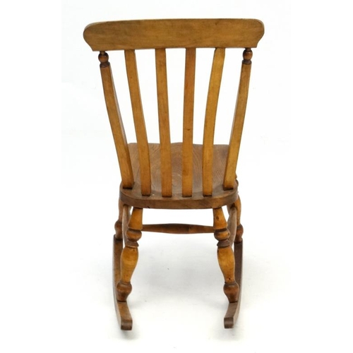 189 - A c.1900 High Wycombe made lathe back elm seated rocking chair 37 1/4'' high  Please Note -  we do n... 