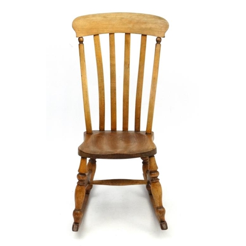 189 - A c.1900 High Wycombe made lathe back elm seated rocking chair 37 1/4'' high  Please Note -  we do n... 