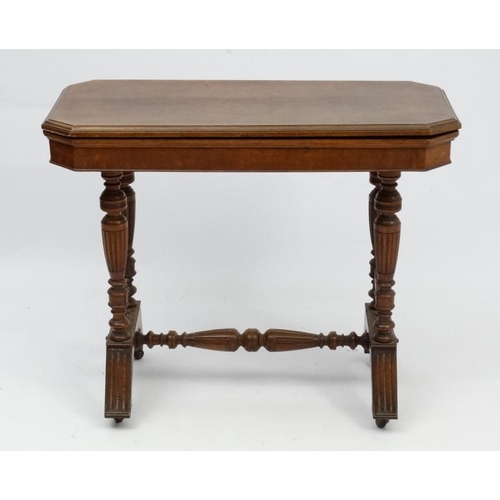 191 - A Victorian stained oak card table with fold over and twist top and gold tooled burgundy leather ins... 