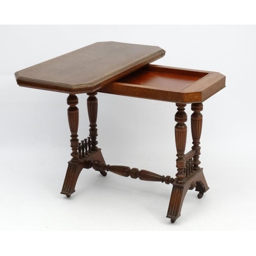 191 - A Victorian stained oak card table with fold over and twist top and gold tooled burgundy leather ins... 