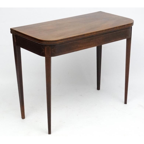 194 - A late 18thC mahogany fold over card table with squared tapering legs and two hinged back legs. 26''... 