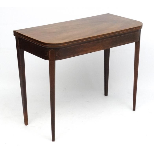 194 - A late 18thC mahogany fold over card table with squared tapering legs and two hinged back legs. 26''... 