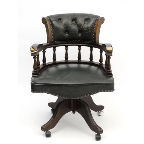 227 - A late 20thC stained walnut and green leather tilt and swivel office chair approx 34'' high  Please ... 