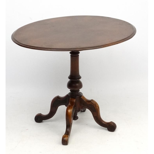 230 - A 19thC oval walnut pedestal occasional table with 4 feet 35 1/2'' long x 29 1/2'' wide x 29'' high ... 