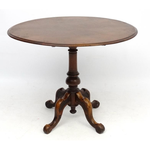 230 - A 19thC oval walnut pedestal occasional table with 4 feet 35 1/2'' long x 29 1/2'' wide x 29'' high ... 