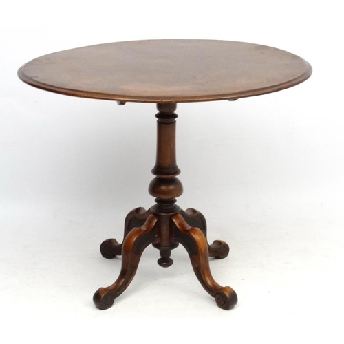 230 - A 19thC oval walnut pedestal occasional table with 4 feet 35 1/2'' long x 29 1/2'' wide x 29'' high ... 