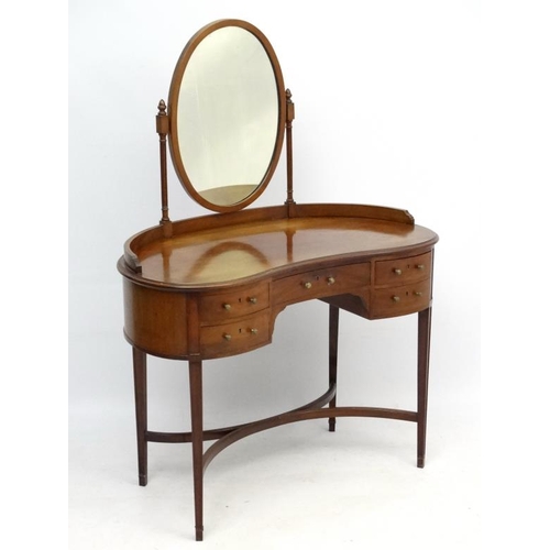 242 - An early - mid 20thC mahogany kidney shaped dressing table and mirror 39 1/2'' wide x 53 1/2'' high ... 