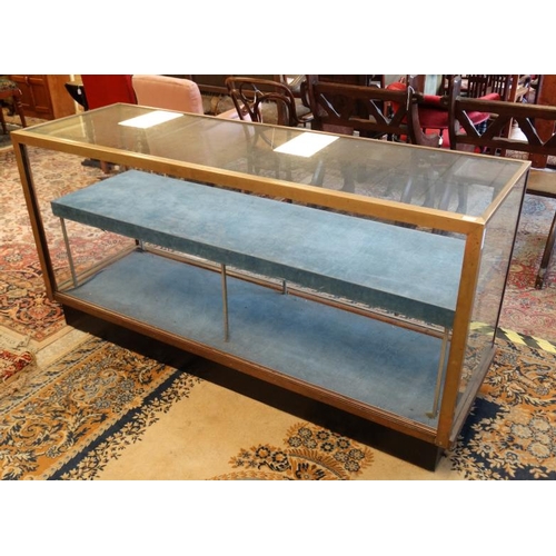 253 - A mid 20thC glazed shop display cabinet of brass and glass 71'' wide x 36'' high x 23'' deep  Please... 