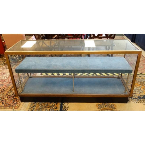 253 - A mid 20thC glazed shop display cabinet of brass and glass 71'' wide x 36'' high x 23'' deep  Please... 