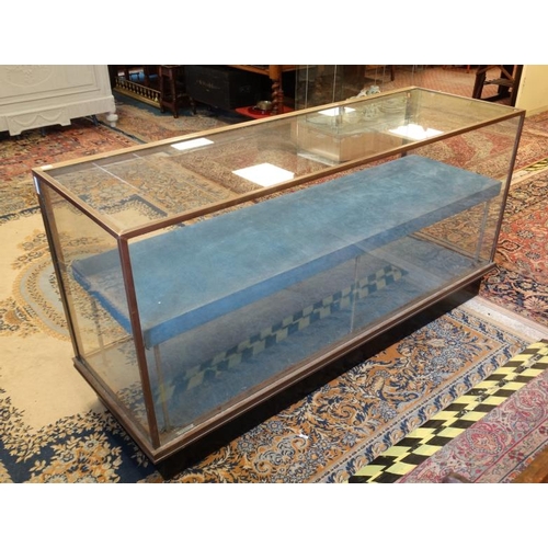 253 - A mid 20thC glazed shop display cabinet of brass and glass 71'' wide x 36'' high x 23'' deep  Please... 