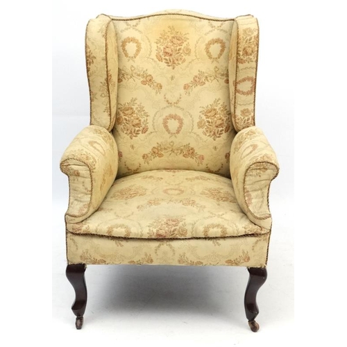 254 - An early - mid 20thC upholstered wingback armchair 39 1/2'' high  Please Note -  we do not make refe... 