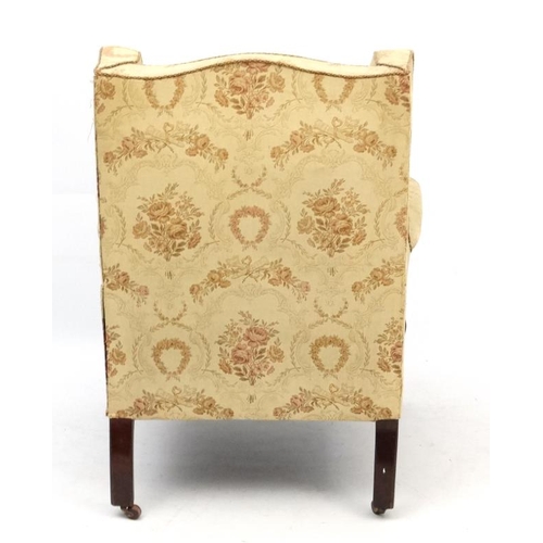 254 - An early - mid 20thC upholstered wingback armchair 39 1/2'' high  Please Note -  we do not make refe... 