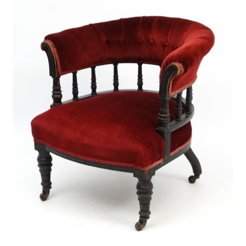 265 - A late Victorian ebonised mahogany Smokers Bow chair with red velvet button back upholstery 28 1/2''... 