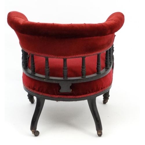 265 - A late Victorian ebonised mahogany Smokers Bow chair with red velvet button back upholstery 28 1/2''... 