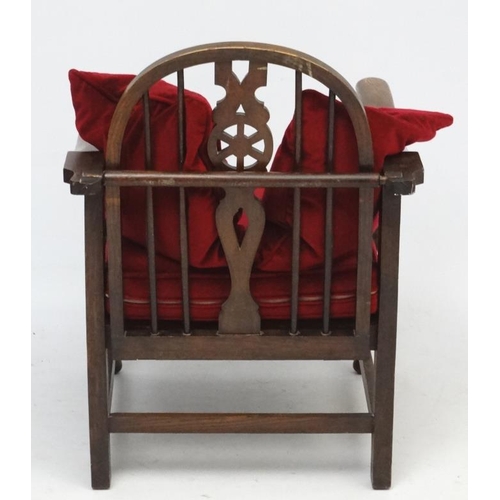 273 - A 1920's wheel back oak reclining open arm chair 33 1/2'' high  Please Note -  we do not make refere... 