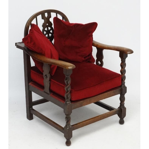 273 - A 1920's wheel back oak reclining open arm chair 33 1/2'' high  Please Note -  we do not make refere... 