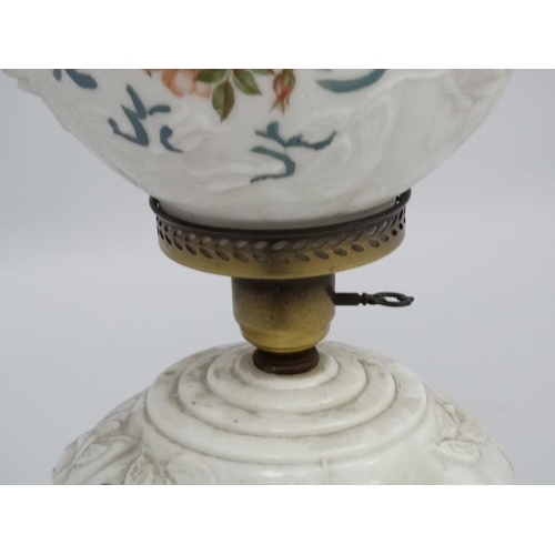 278 - A Victorian style oil lamp with transfer floral style decoration and moulded white glass shade and r... 