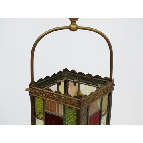 284 - An Edwardian brass and leaded stained glass multicoloured pendant hall lantern / light shade. The wh... 