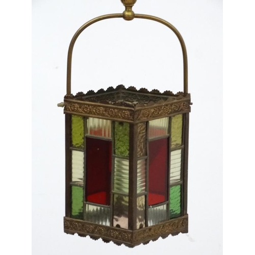 284 - An Edwardian brass and leaded stained glass multicoloured pendant hall lantern / light shade. The wh... 