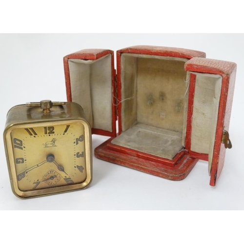 309 - Duverdrey & Bloque Cased alarm clock : an Art Deco square leather cased (and silk lined ) with Arabi... 