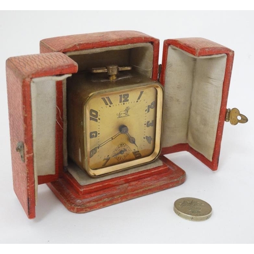 309 - Duverdrey & Bloque Cased alarm clock : an Art Deco square leather cased (and silk lined ) with Arabi... 