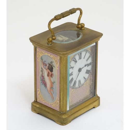 314 - Carriage Clock : a porcelain panelled 5 1/4'' high ( handle up) carriage clock ( timepiece ) with ov... 